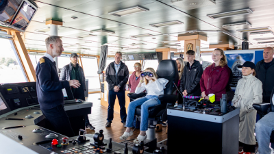 Captain Mackay welcomes a group of visitors to the bridge of RRS Discovery