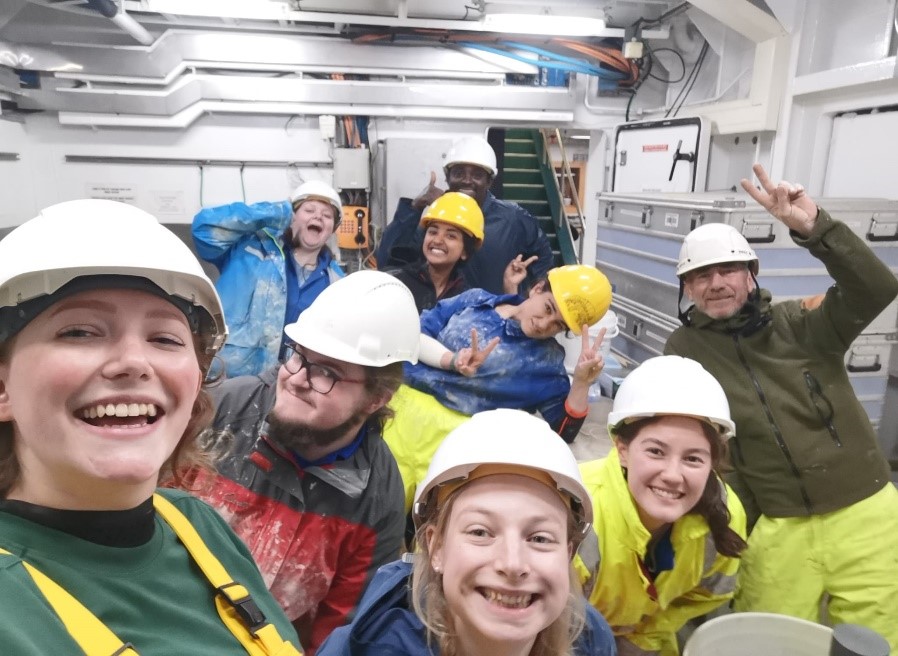 Cheerful scientists and ship's crew after a busy night shift