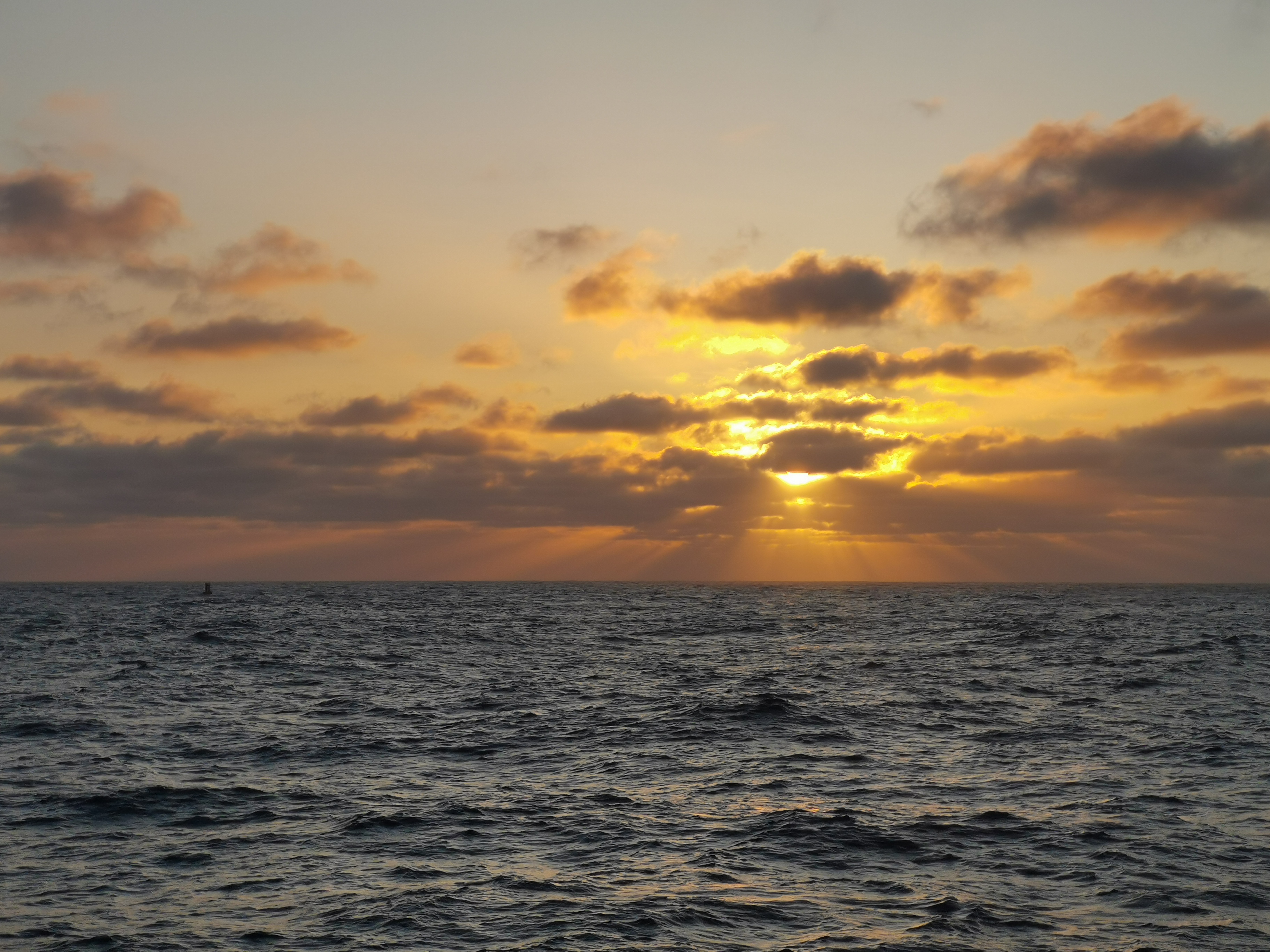 The sun setting over the PAP1 mooring which collects a variety of data and informs the Met Office weather forecasts (seen very small on the horizon to the left).  