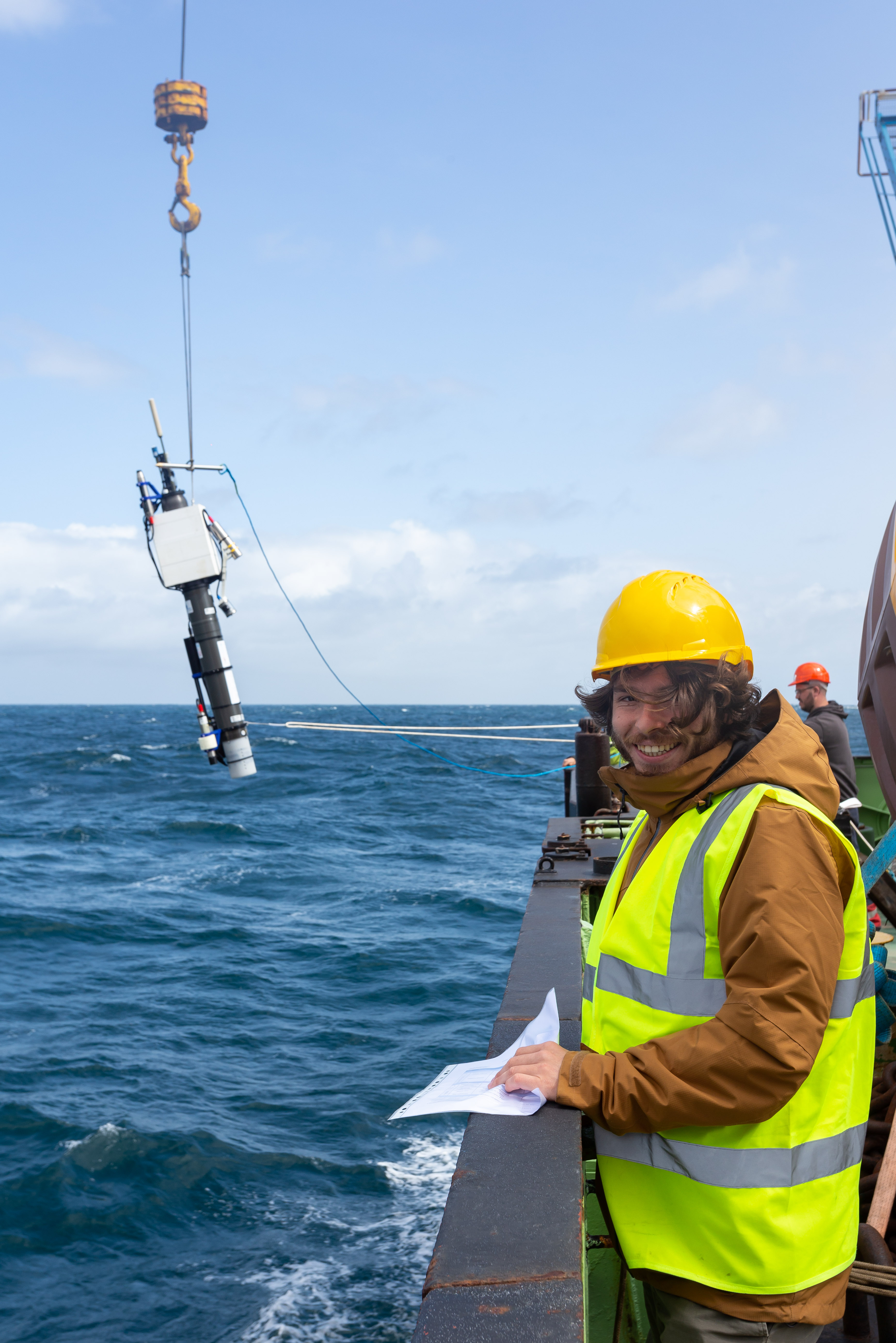 Scientists deploying an oceanographic instrument